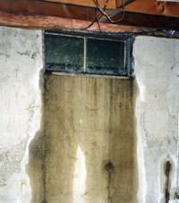 Flooding through basement windows in a Milton home.