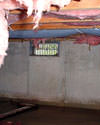 Delaware & Maryland crawl space with vents, showing mold, rot, and fiberglass insulation dripping off the ceiling.