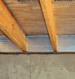 SilverGlo™ insulation installed in a floor joist in Clayton