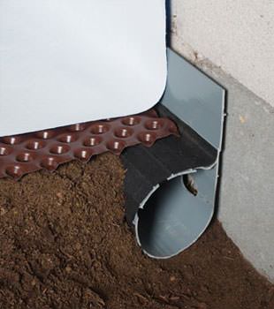 Closeup of a crawl space drainage system installed in Millsboro