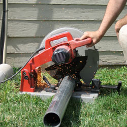 Cutting the support beam for a crawl space jack post outside a Dover home.