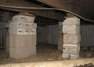 crawl space repairs done with concrete cinder blocks and wood shims in a Smyrna home